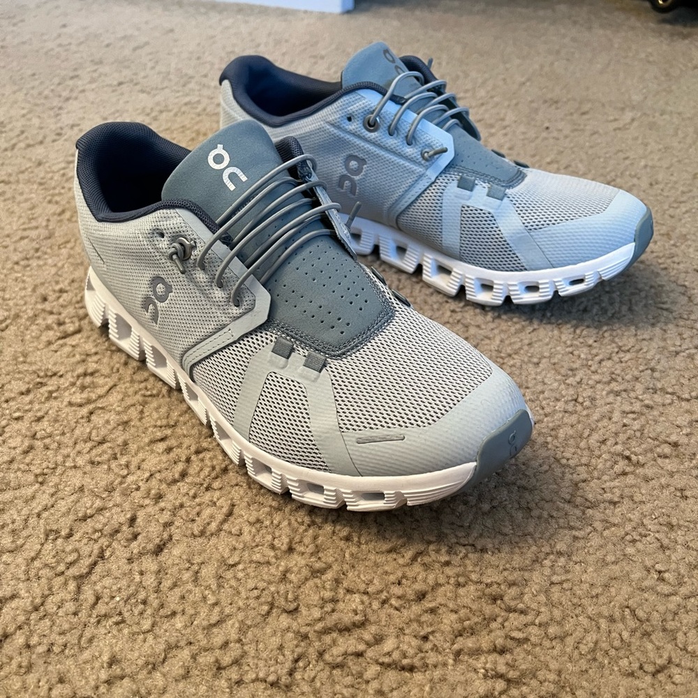 A pair of On Running Cloud 5’s that have been worn once. Size 9.5, Surf & Cobble